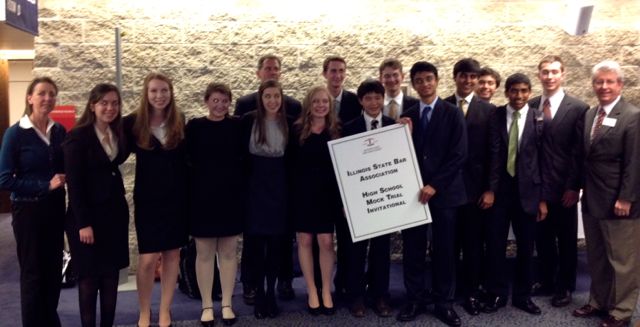 Sponsoring Committee Chair Lauren DeJong (left) and ISBA Board member Carl Draper (right) congratulate Hinsdale Central High School's mock trial team on its victory.