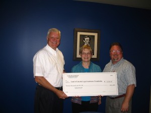 IBF Grants Committee Member Judge James Wexstten of Mt. Vernon presents a $20,000 grant to Linda Zazove, Deputy Director and Christopher Dain, Director of Development, of Land of Lincoln Legal Assistance Foundation. 